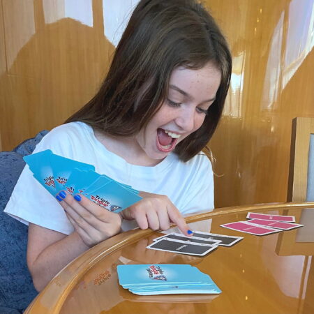 Girl playing Triple Tongue Twister card game